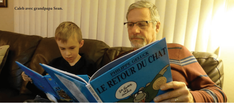 A grandfather reading with his grandson