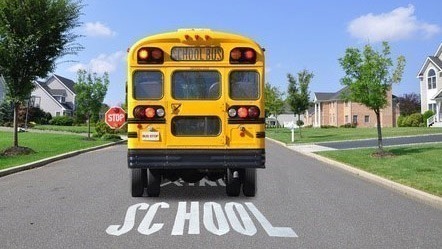 A yellow school bus with flashing lights