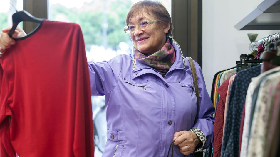 An elderly lady shopping for clothes