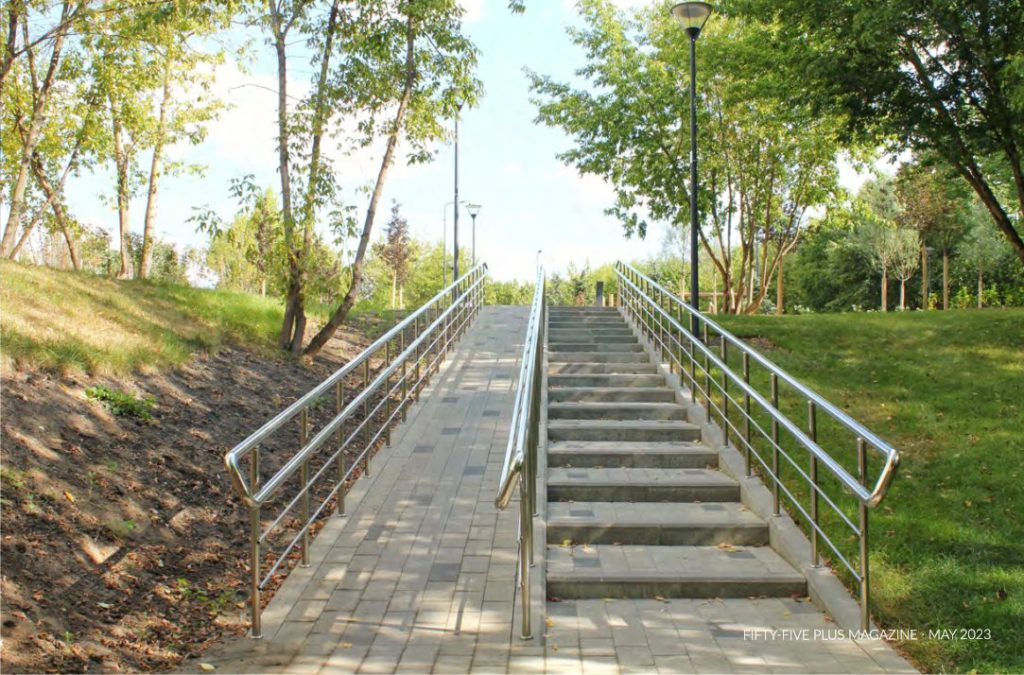A ramp for wheelchair up a slope in a park.